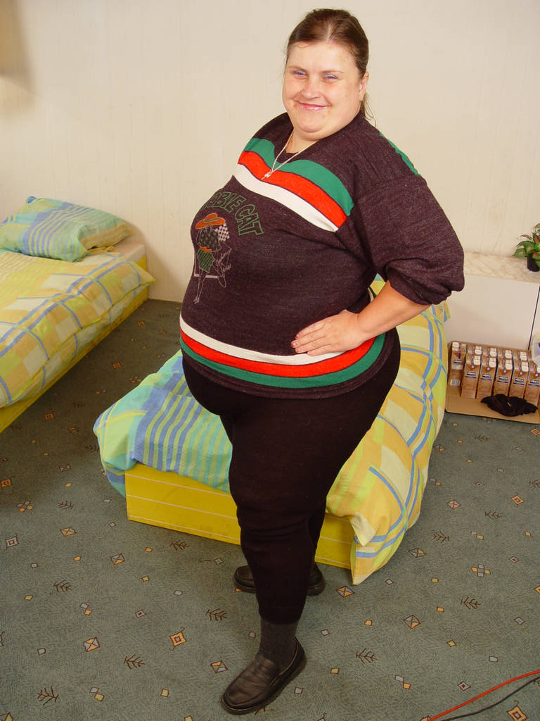 Fat granny Mitzi smiling playfully while preparing to give her stud a deep blowjob